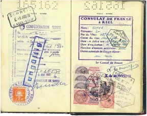 Open passport with a variety of colorful stamps, including one from the &ldquo;Consulat de France &agrave; Kiel&rdquo;