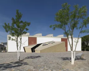 Two small trees stand next to the sides of the Academy Building's entrance. 