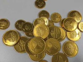 Chocolate coins. These are wrapped in shiny golden foil embossed with Hanukkah lamps.