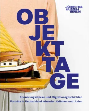 Book cover with picture detail showing a person, of whom only the hull is visible, holding a wooden board with a model ship, above the picture the book title: &ldquo;Object Days. Memorabilia and migration stories. Portraits of Jews living in Germany.&rdquo;