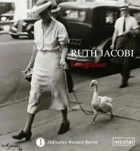 Catalouge cover for exhibition &ldquo;Ruth Jacobi&rdquo;: black and white photograph of a woman with a large hat walking a white duck on a leash.
