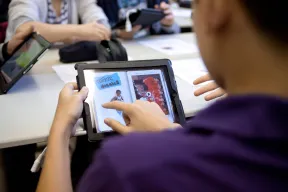 A student swipes across the iPad.