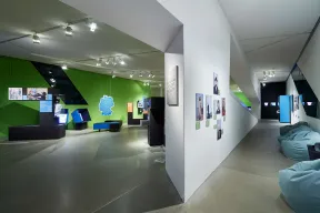 View of an exhibition hall with Hebrew letters and bean-bag chairs 