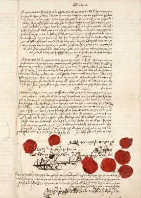 Old page of hand written cursive ink text with multiple red wax stamps at the bottom of the page