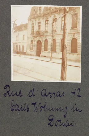 Black and white photograph of a house, glued into a photo album, with captions.
