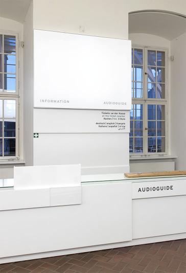 View of the museum lobby and the information desk, where you can borrow an audio guide. 