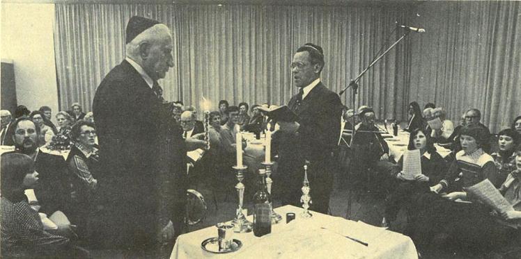 Black-and-white photograph of a festive Shabbat ceremony