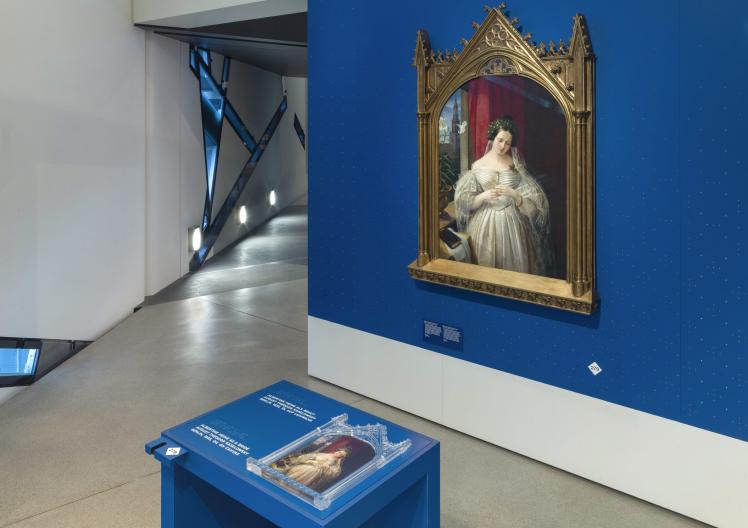 View into the exhibition with painting and media station