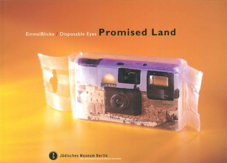 Cover of the catalog for the exhibition “EinmalBlicke/Disposable Eyes”. It shows a disposable camera in plastic foil with a photo of Jerusalem’s Old City printed on its housing.