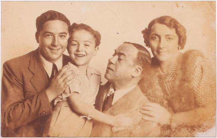 sepia-tone family photograph Husband and wife with one adult son and one school-aged son